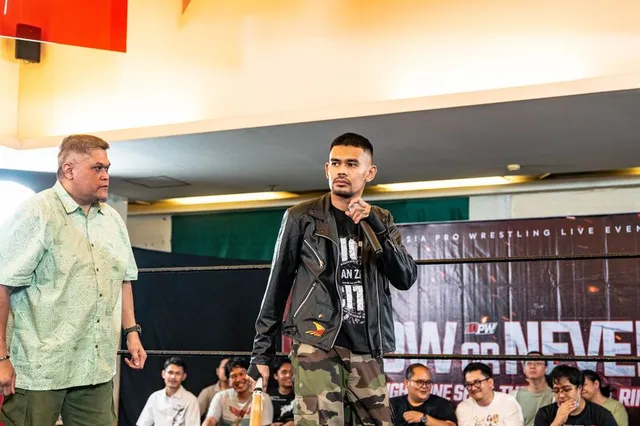 A wrestler makes his entrance, mic in hand, at IDPW Now or Never
